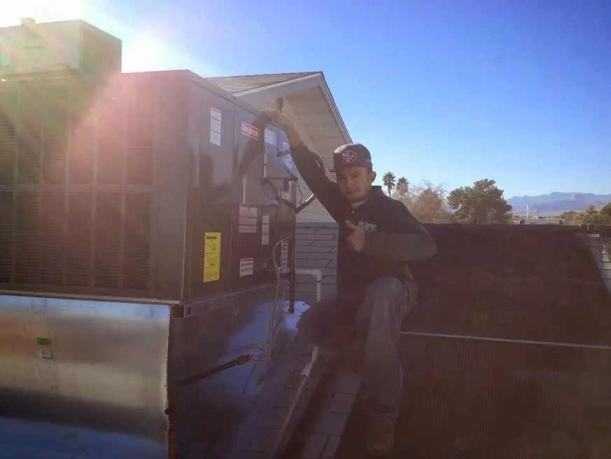 HVAC technician performing Boiler Repair on a rooftop unit in Bellevue